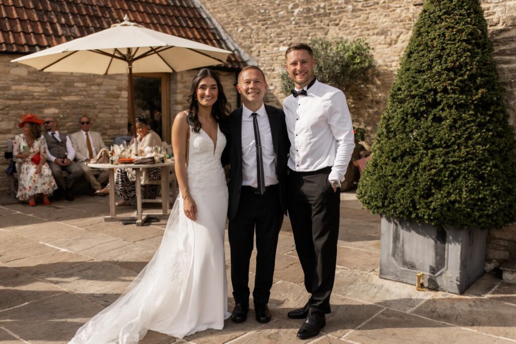 bath magician stood with the bride and groom after showing them some of his magic